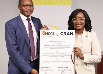 Two professionals in business attire hold a large certificate featuring NCC and CRAN logos.